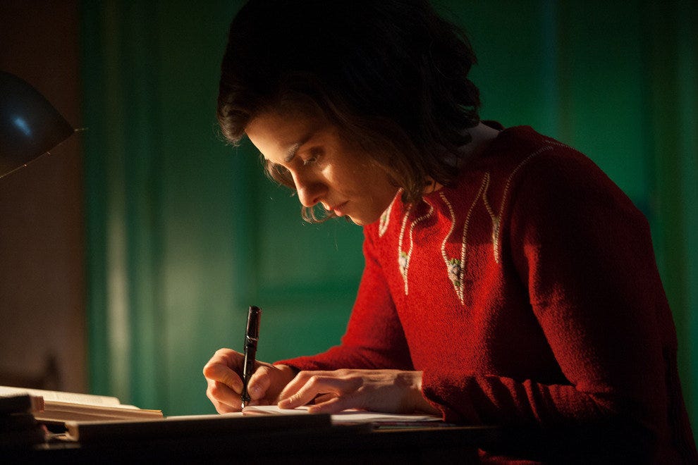 Anne Frank, played by actress Rosa da Silva, writes in her diary