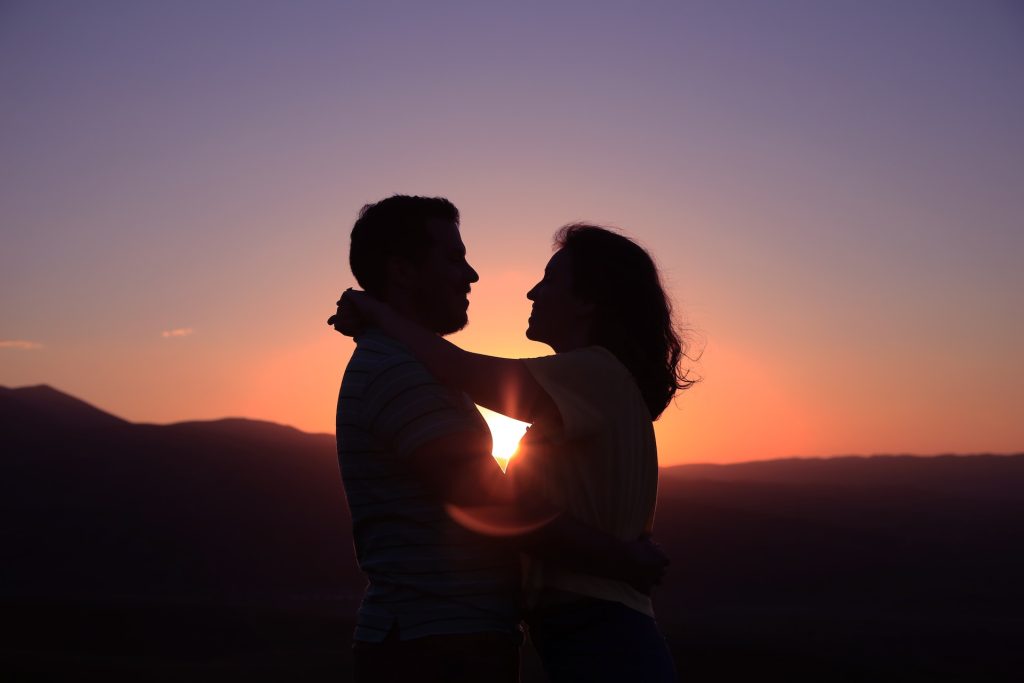 Couple embracing at sunset